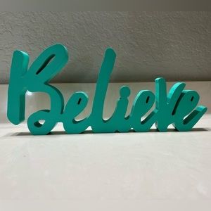 Teal believe sign